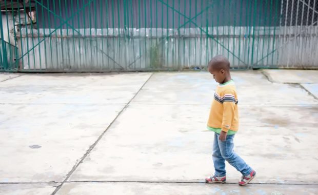 Solitary child walking with head down