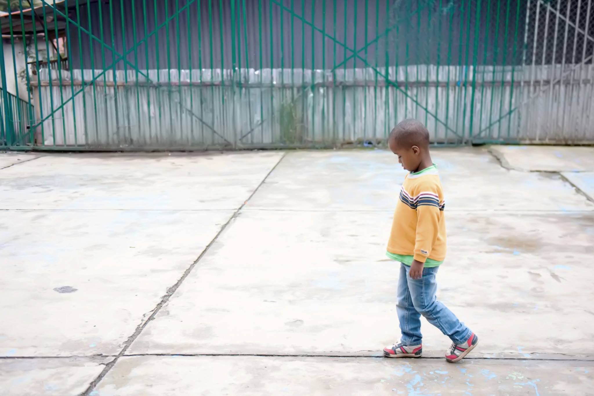 Solitary child walking with head down