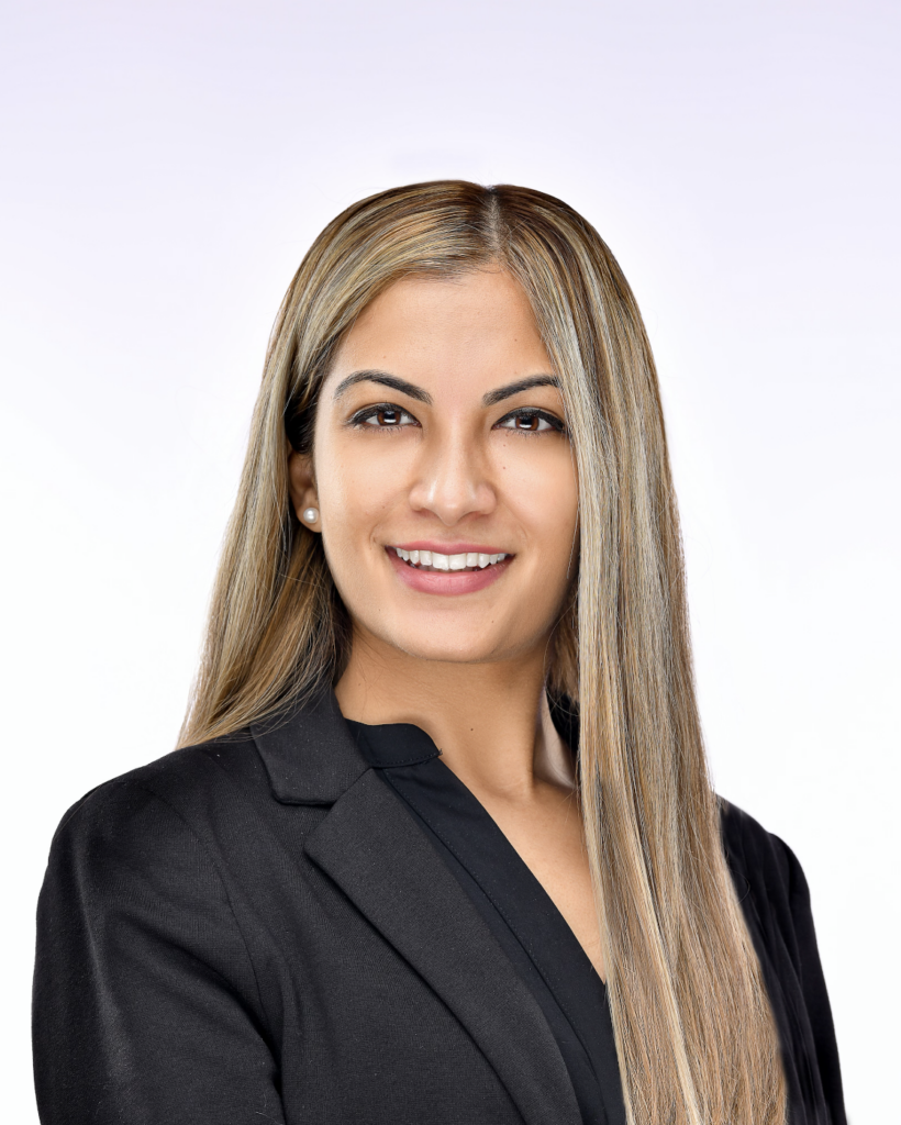 Fatema Jaffer in a black blazer in front of a white background.