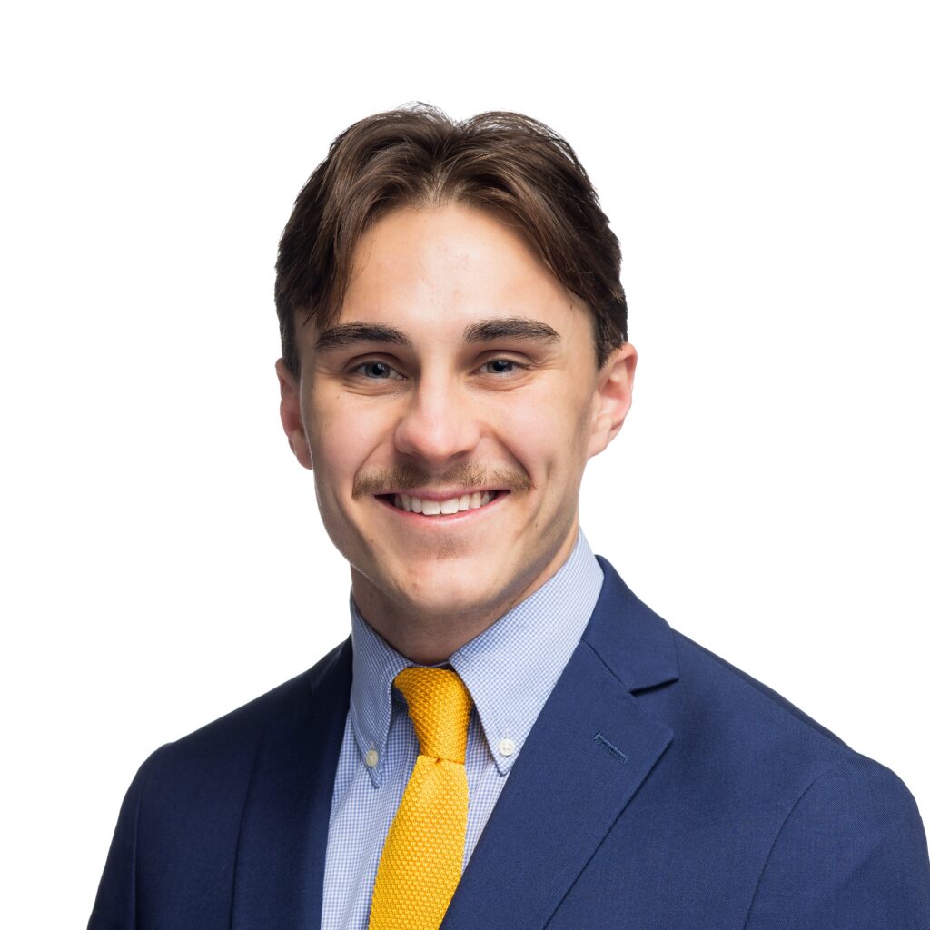 James Limbaugh headshot, navy blazer, yellow tie, blue shirt, in front of white background.
